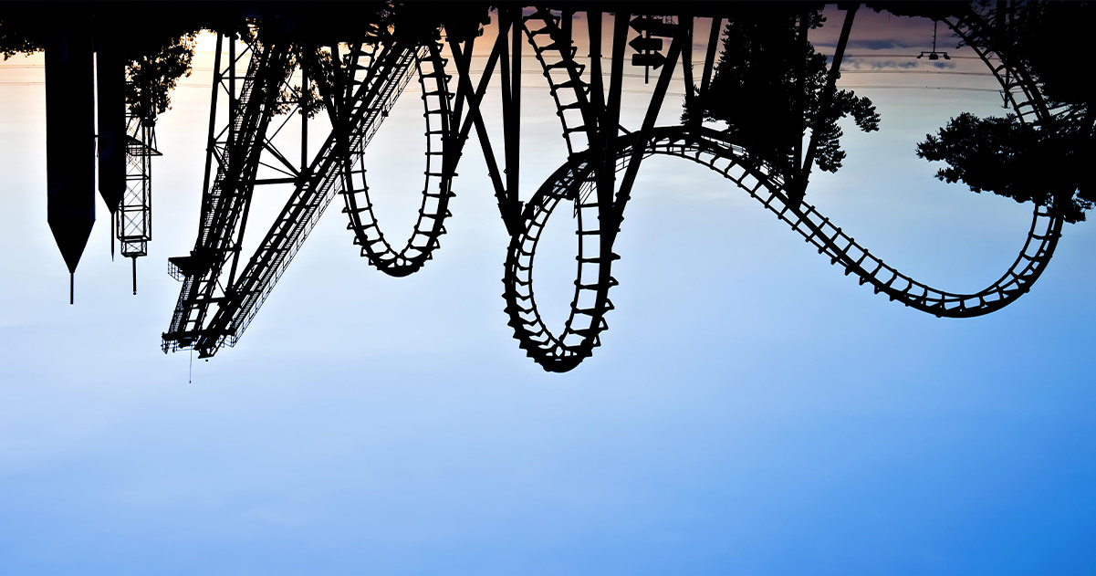 An upside down sunset photo of a rollercoaster