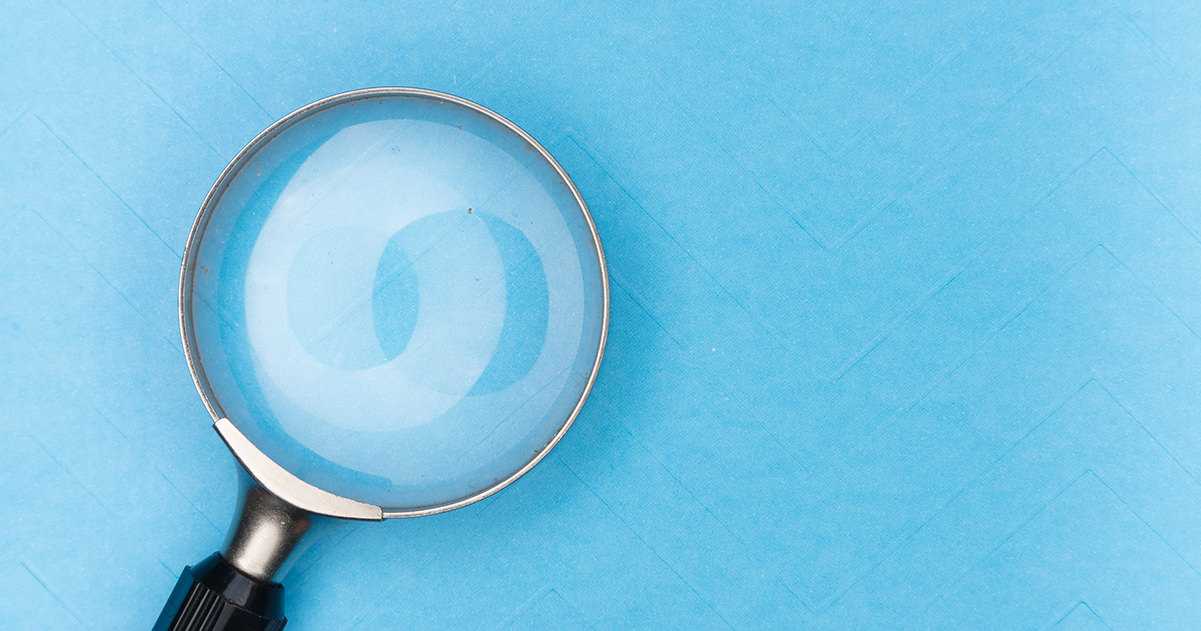 A magnifying glass on a blue background, sybmolical image for searching for things on google.